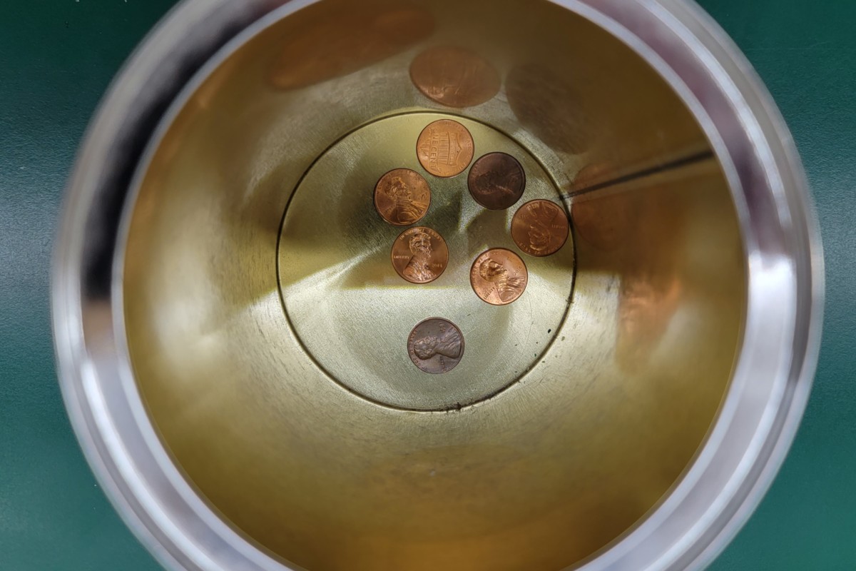 Overhead view of pennies in a coffee can.